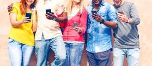 Teenagers texting mobile phone messages row on pink background -