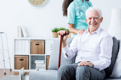 Happy senior disabled man and caregiver